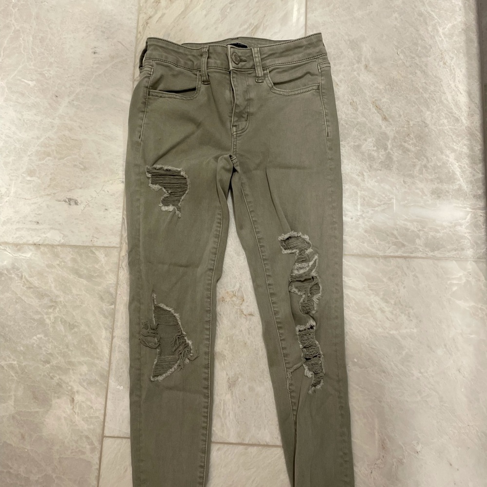 green ripped jeans
